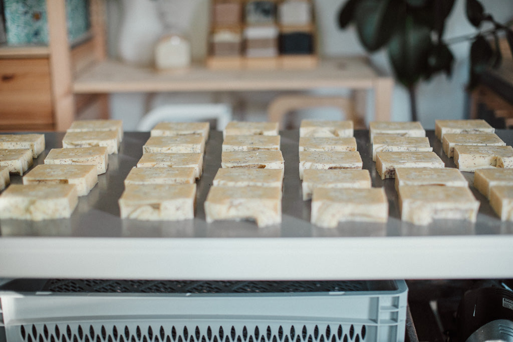 Rows of soap bars on a table with a blurred background