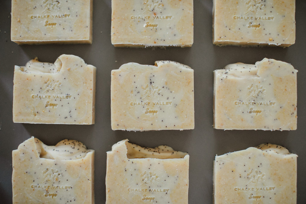 Multiple bars of Chalk Valley Soaps arranged in a grid on a dark surface.